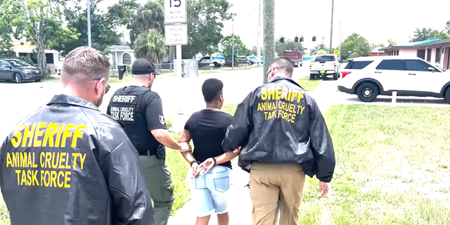 Officers escorting away Green