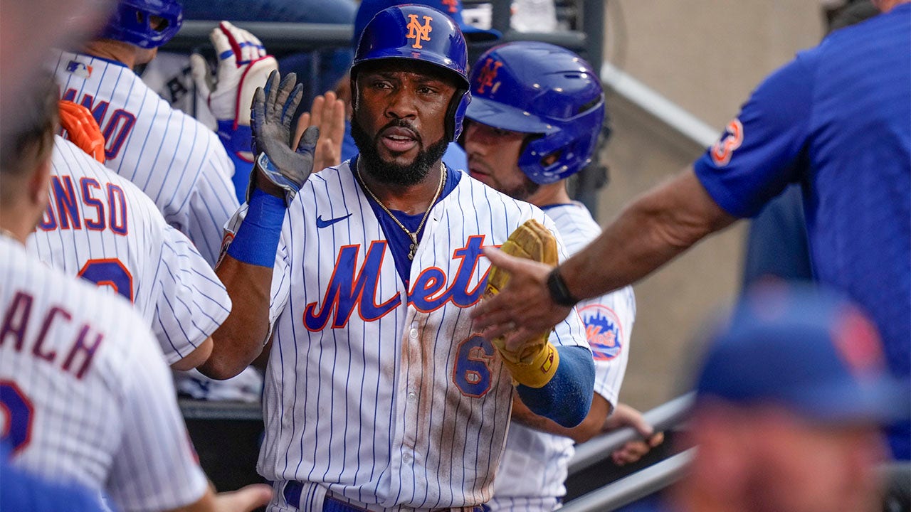 Starling Marte celebrates in dugout