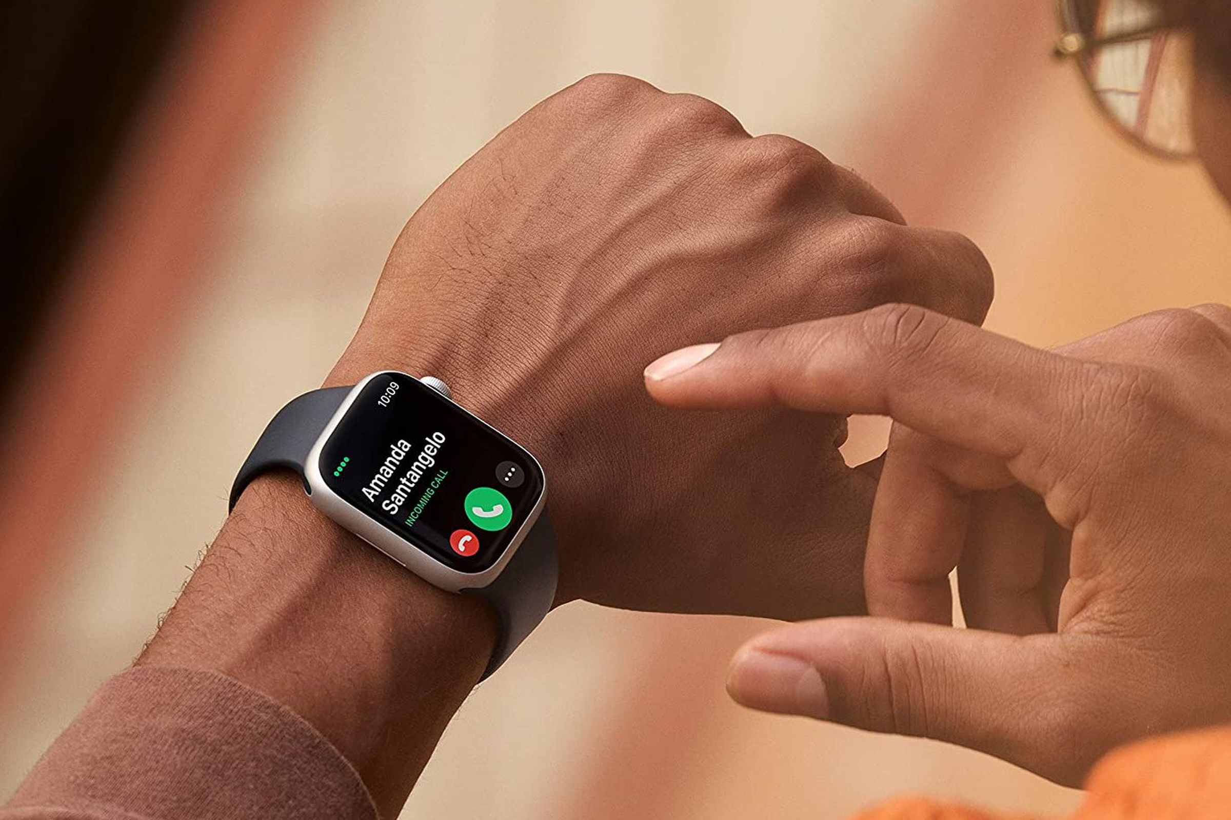 Somebody wearing and about to tap on the Apple Watch Series 8.