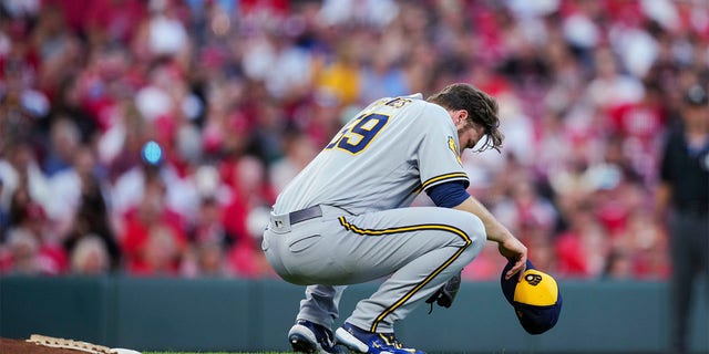 Corbin Burnes crouches behind the mound