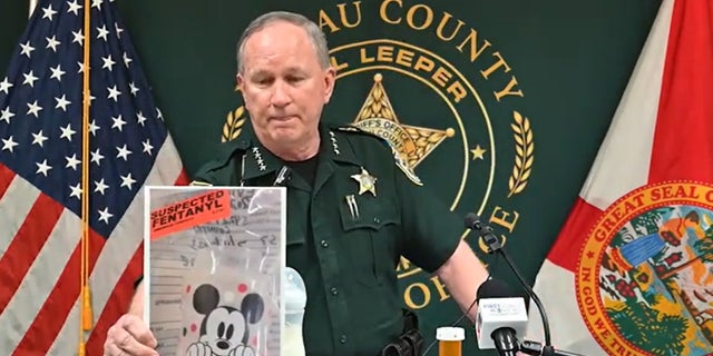 Sheriff Bill Leeper with evidence photo at press conference