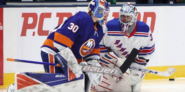 Igor Shesterkin and Ilya Sorokin warm up before an NHL in 2021