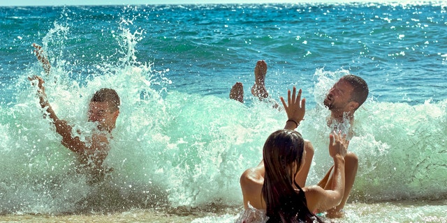 People playing in ocean