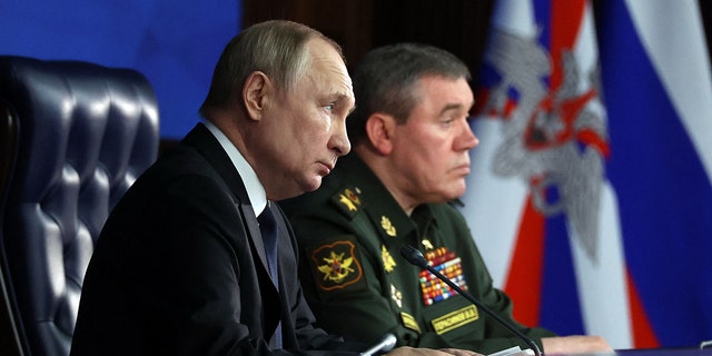 Russian President Vladimir Putin sits next to Russian General Staff Valery Gerasimov