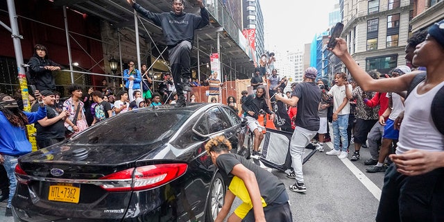 Rioter on top of car during Union Square chaos