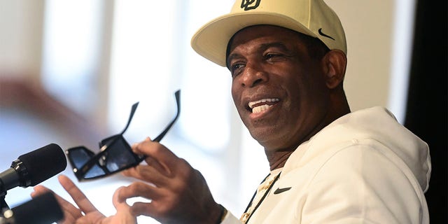 Deion Sanders speaks to reporters