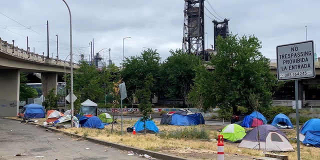 homeless tents in front of steel bridge in Portland, Oregon