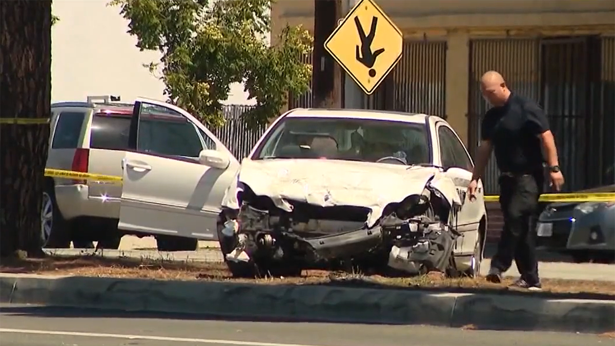 Smashed front end of white Mercedes