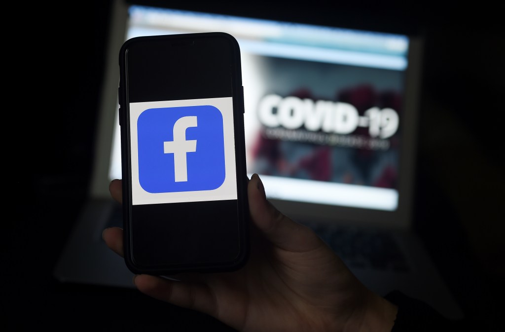 In this file photo the Facebook logo is displayed on a mobile phone screen photographed on coronavirus COVID-19 illustration graphic background on March 25, 2020 in Arlington, Virginia.