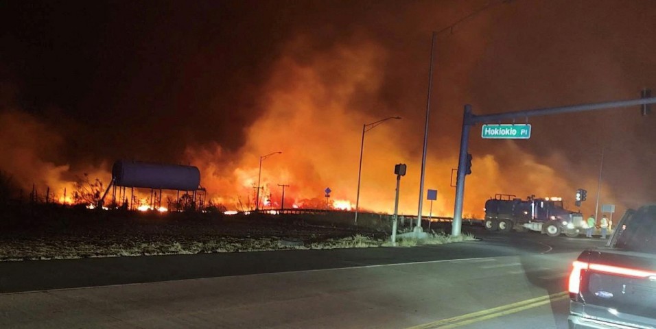 A wildfire burns on the island of Maui near an intersection in Lahaina, Hawaii, on August 9, 2023. 