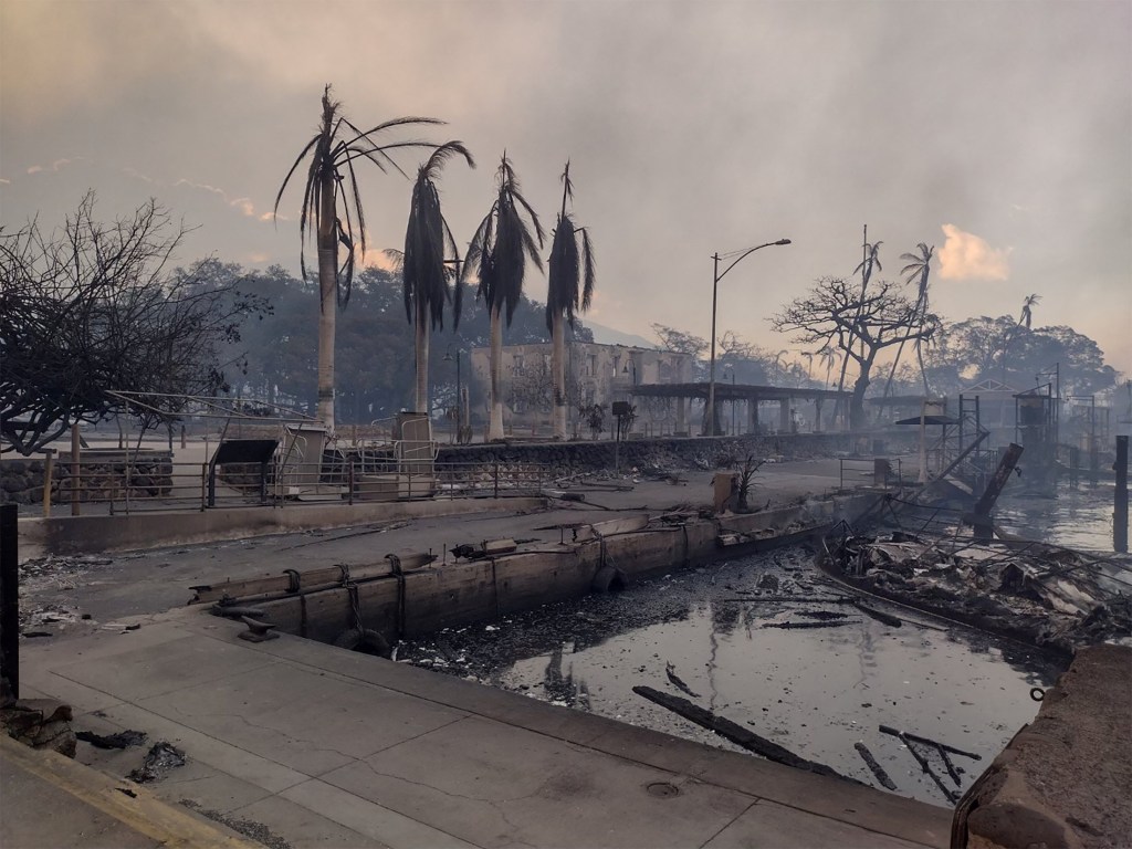 A charred boat lies in the scorched waterfront after wildfires fanned by the winds of a distant hurricane devastated Maui's city of Lahaina, Hawaii, on August 9, 2023.  