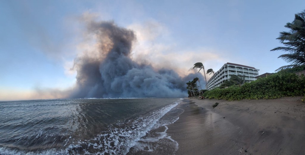 Smoke billows near Lahaina as wildfires driven by high winds destroy a large part of the historic town of Lahaina, in Kahului, Hawaii, on August 9, 2023.