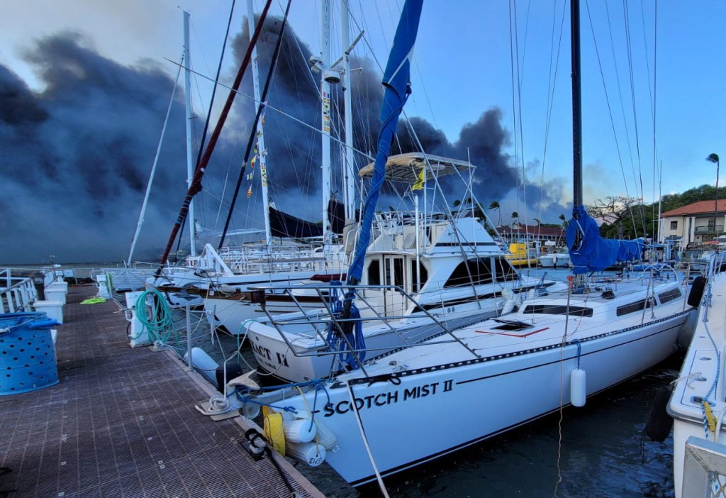 Smoke billows near boats docked at Lahaina as wildfires driven by high winds destroy a large part of the historic town of Lahaina, in Kahului, Hawaii, on August 9, 2023. 