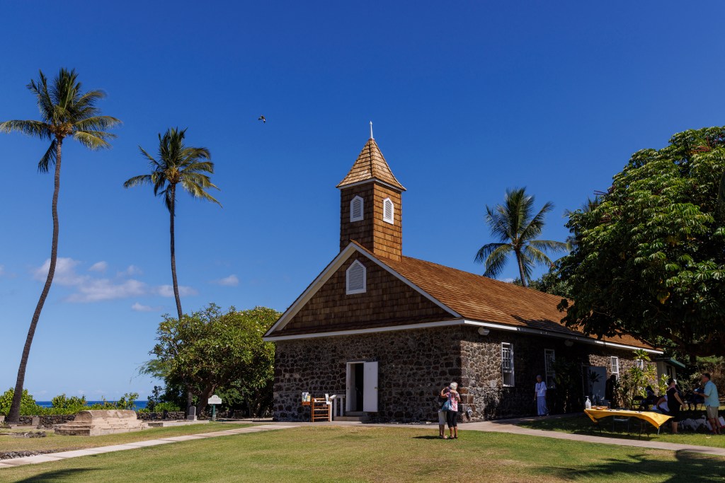 People hug as they arrive for a morning service at Keawalai Church, founded in 1832, in Makena on Hawaii's Maui island, in Hawaii, U.S., August 13, 2023.  