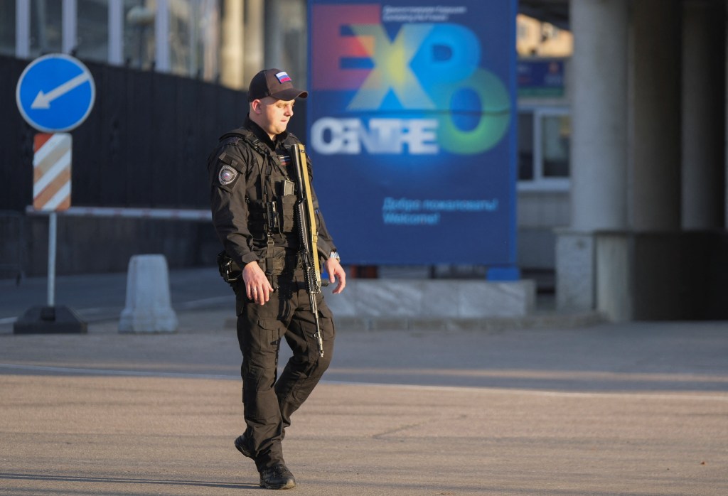 A Russian law enforcement officer secures the area near the accident scene following a reported Ukrainian drone shot down in Moscow, Russia, on Aug. 18, 2023. 