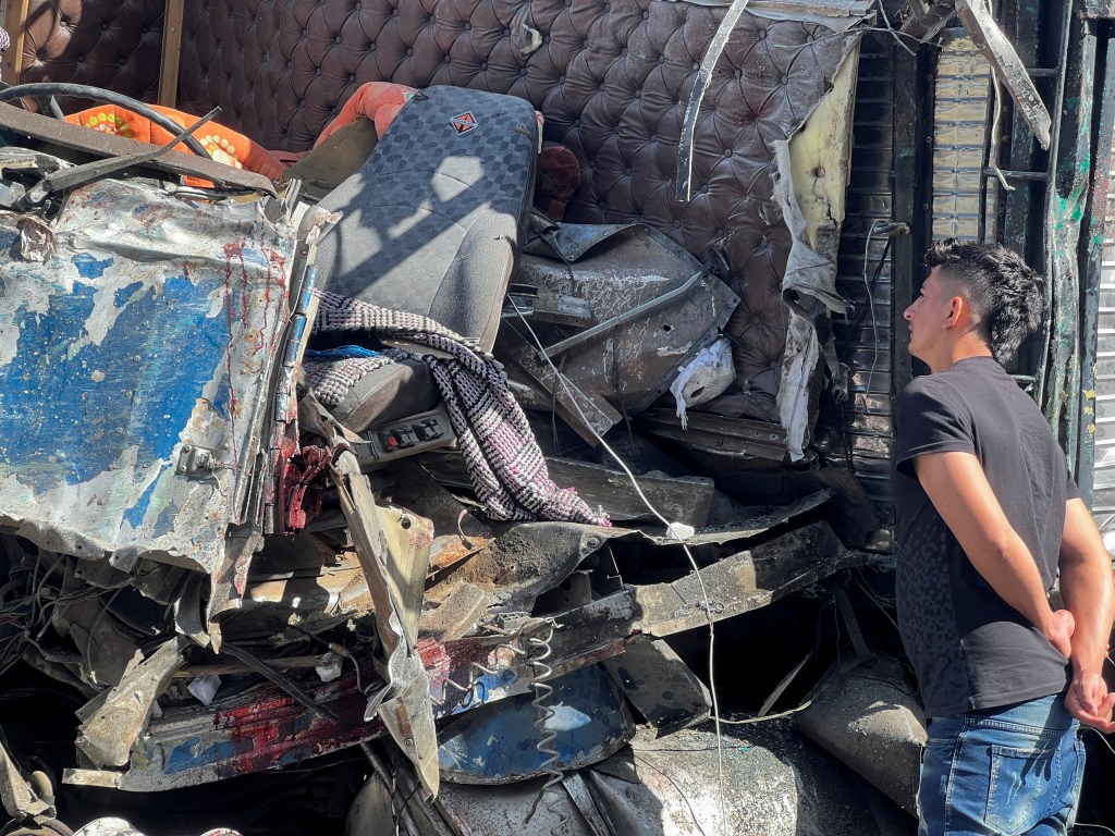 A man observes the wreckage of a truck that crashed with a bus, in a road accident which left over a dozen passengers dead, in Tepelmeme Villa de Morelos, Mexico on Aug. 22, 2023. 