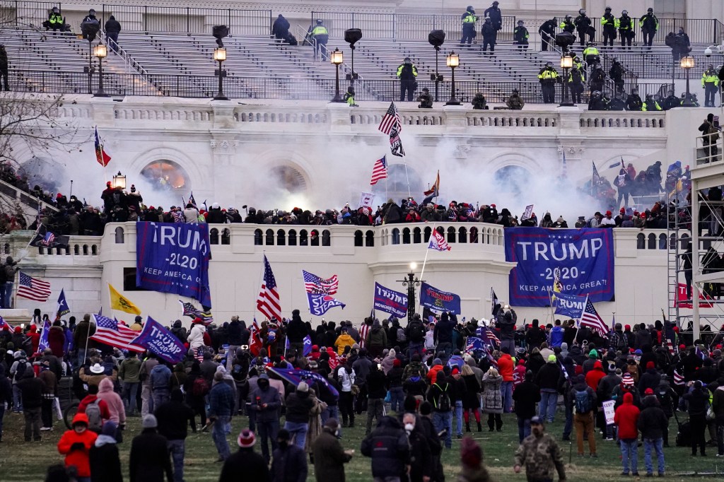 Violent insurrectionists loyal to President Donald Trump, storm the Capitol, Jan. 6, 2021, in Washington. Information gathered and posted by a network of online sleuths led to the arrests Tuesday, Feb. 8, 2022, of two men, Matthew Jason Beddingfield and Eric Gerwatowski, charged separately with storming the U.S. Capitol last year, the FBI said in court filings.