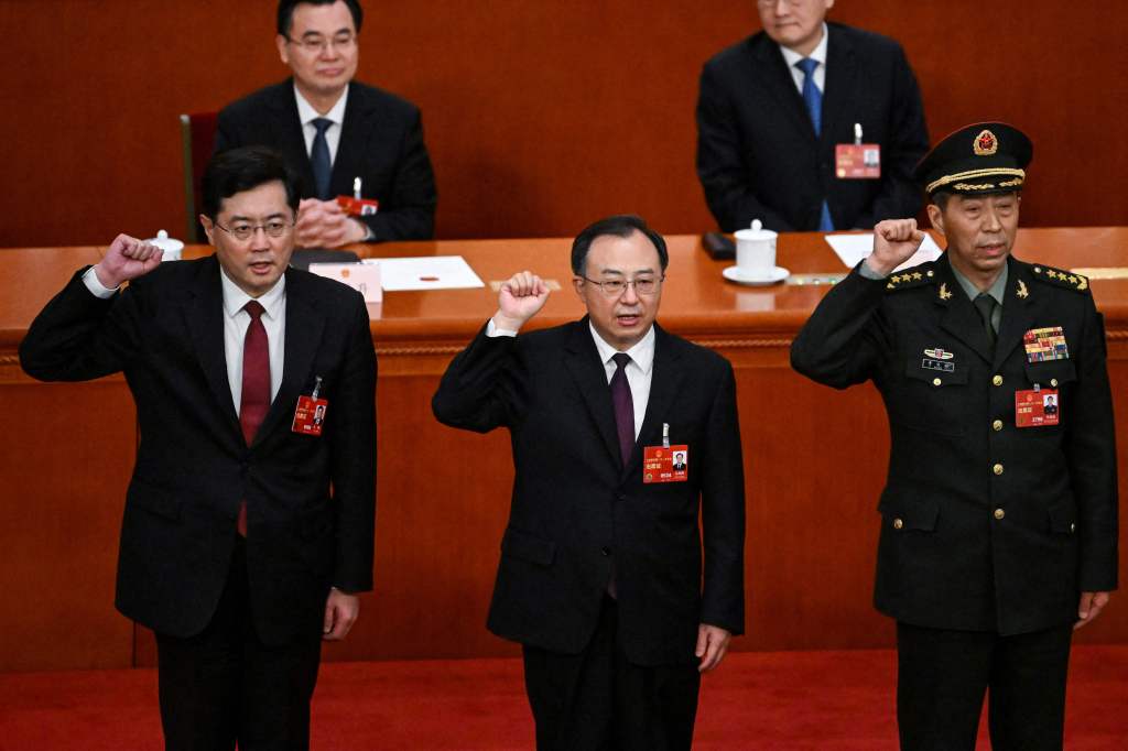 Newly-elected Chinese state councilor Qin Gang swear an oath after being elected during the fifth plenary session of the National People's Congress (NPC) at the Great Hall of the People in Beijing on March 12, 2023. 