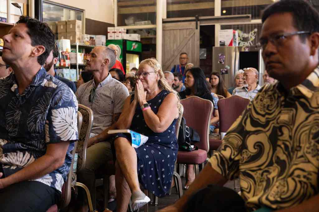 An attendee reacts during a Sunday church service held by Pastor Brown of Lahaina's Grace Baptist Church, at Maui Coffee Attic in Wailuku, central Maui, Hawaii on August 13, 2023.