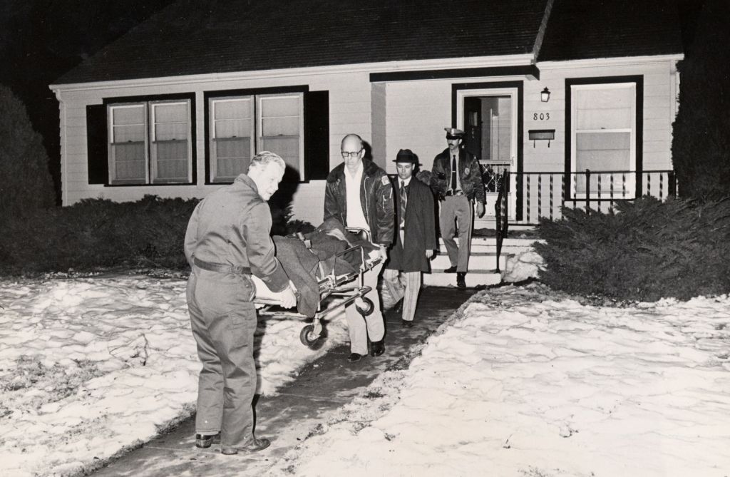 In this 1974 photo, the body of one of the Otero family members is removed from the Otero home in Wichita, Kan. 