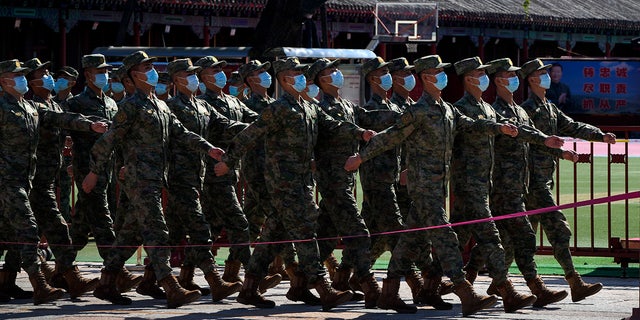 Chinese soldiers march during CCP ceremony