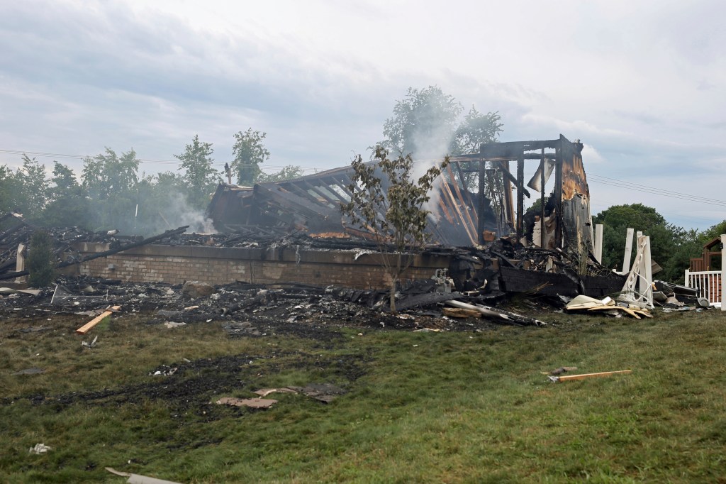The ruins of a home that was destroyed in an explosion stands at the intersection of Rustic Ridge and Brookside drives in Plum, Pa., on Saturday, Aug. 12, 2023. 