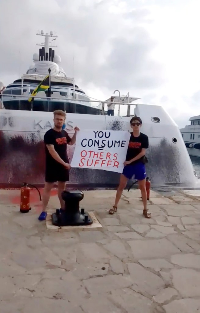 Protesters demonstrate in front of a super yacht belonging to Walmart heir Nancy Walton Laurie after spray paining it in Ibiza, Spain on July 16, 2023. 