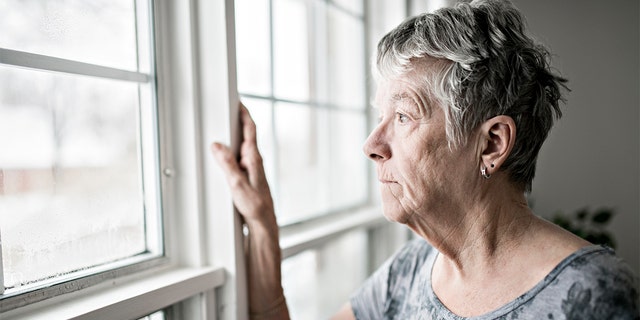 sad and lonely woman at window