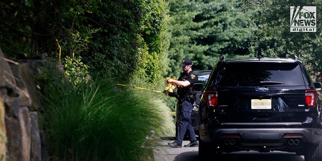 Police cars outside a suburban home