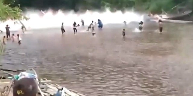 A bridge collapses, splashes in the water with people in Indonesia