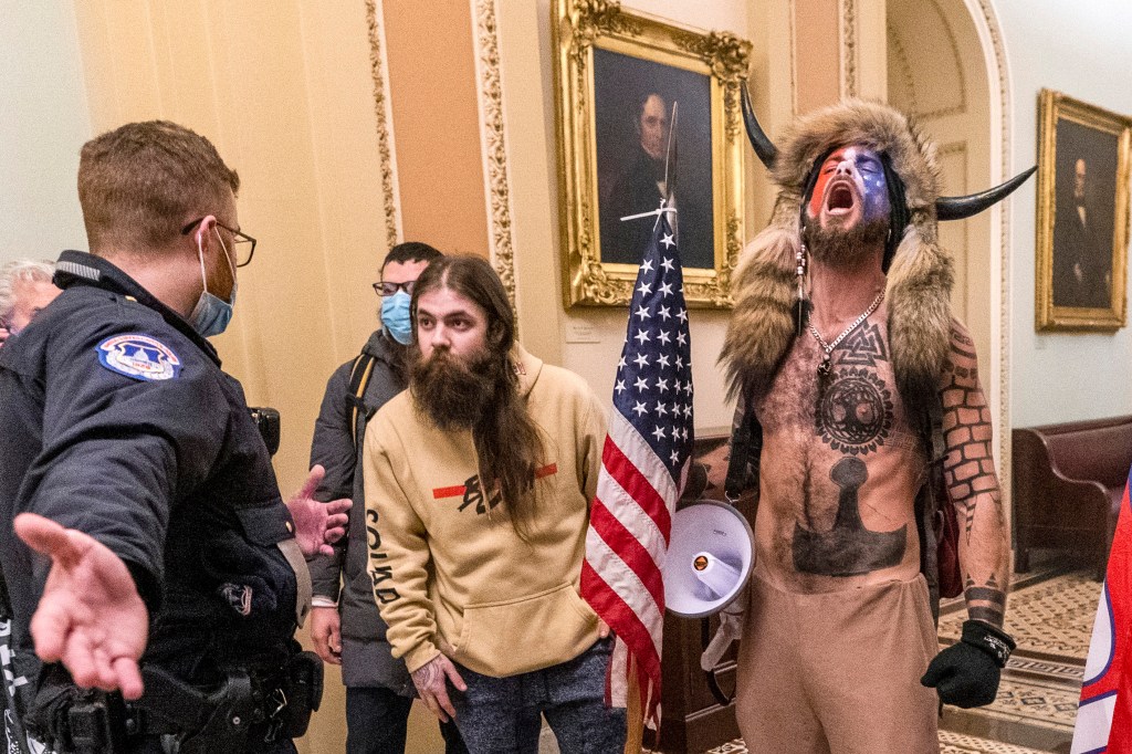 Rioters are confronted by U.S. Capitol Police officers outside the Senate chamber inside the Capitol during the capitol riot on Jan. 6, 2021.