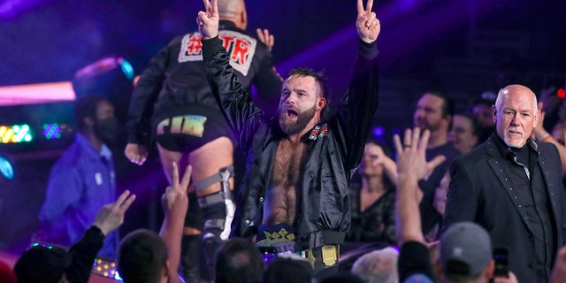 Cash Wheeler goes to the ring during an AEW event