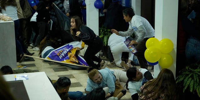 Supporters of Fernando Villavicencio take cover during shooting