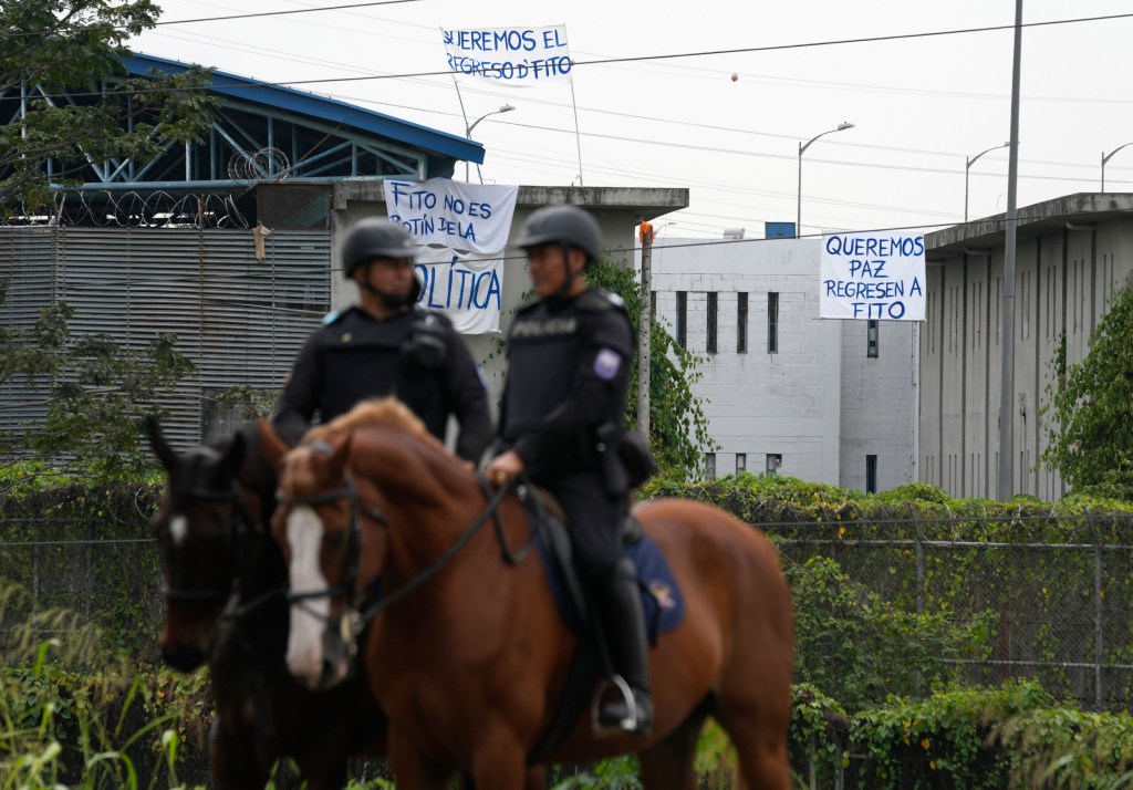 Police guard the Zone 8 Deprivation of Liberty Center where inmates protest to demand the return of Los Choneros leader Adolfo MacÃas, alias "Fito," in Guayaquil, Ecuador, on Aug. 14, 2023.