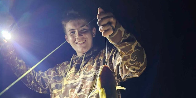 Evan Kinley holds fish