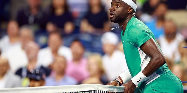 Frances Tiafoe touches net