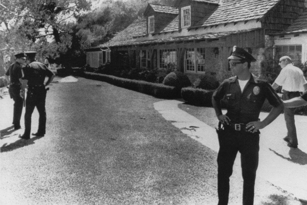 Policemen stand guard outside the home of film director Roman Polanski in west Los Angeles, following the murder of his wife Sharon Tate — as well as four of the wife's friends — in August of 1969.  