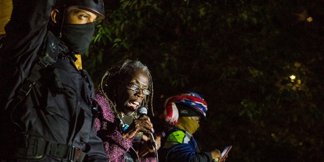 Hardesty with protesters in riot gear