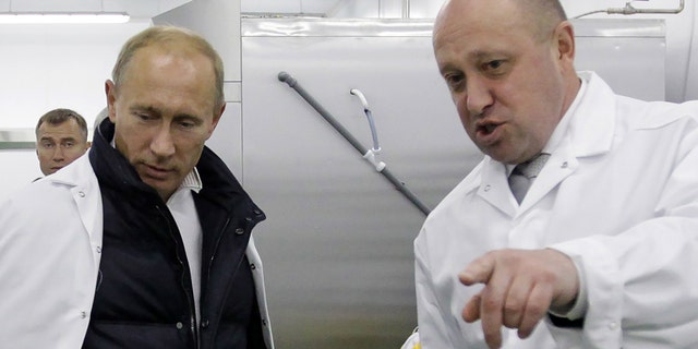 Businessman Yevgeny Prigozhin shows Russian Prime Minister Vladimir Putin