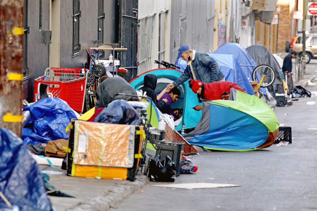 Homeless people  are seen consuming illegal drugs in an encampment in the Tenderloin district of San Francisco.