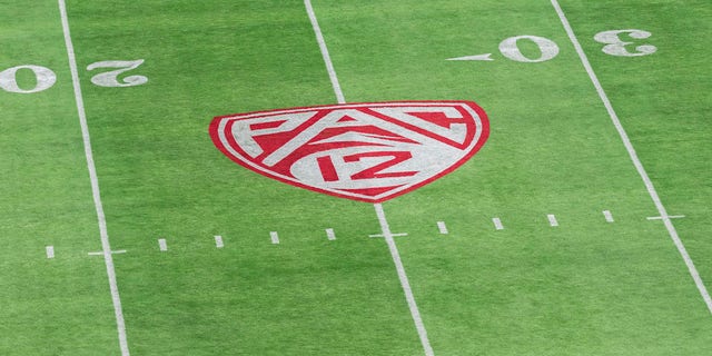 The Pac 12 logo on a football field