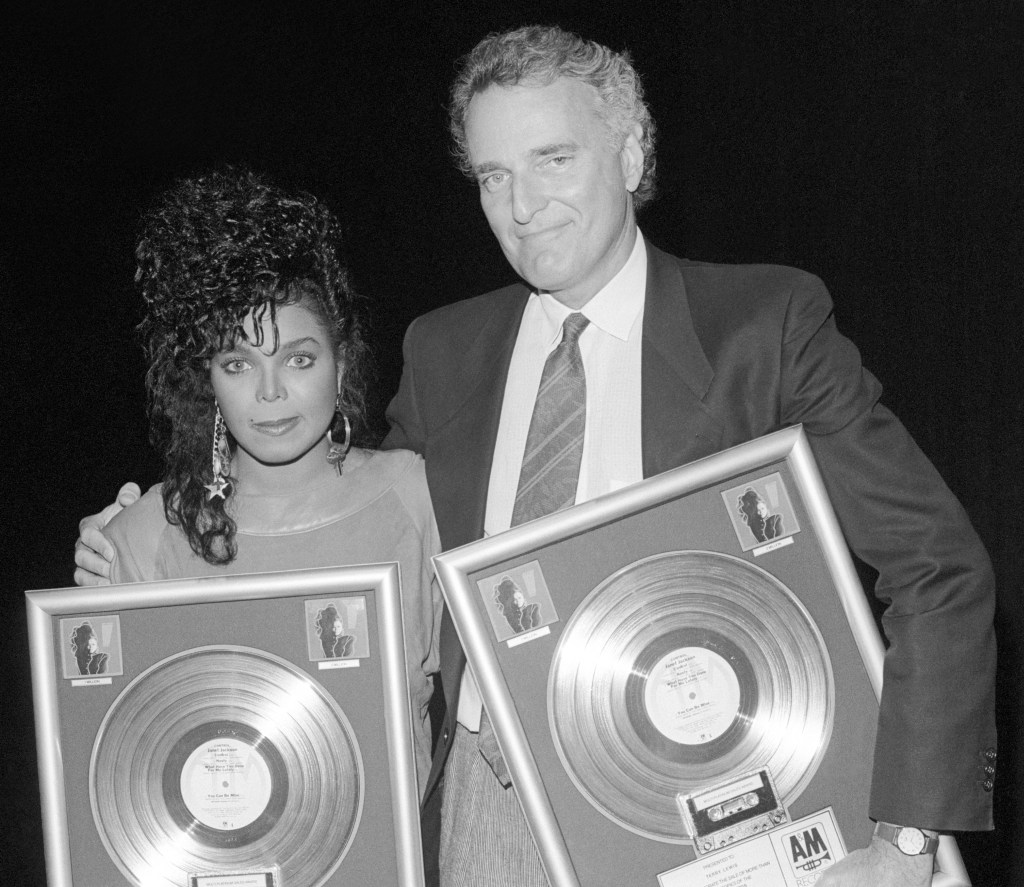 Jerry Moss and Janet Jackson pose for a portrait for 2,000,000 copies of the album "Control" in Los Angeles in 1986. 