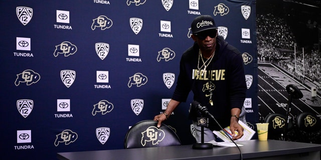 Deion Sanders speaks to reporters