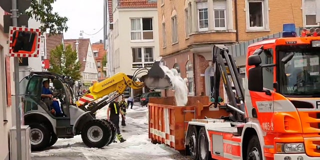 hail dumped from plow into dump truck