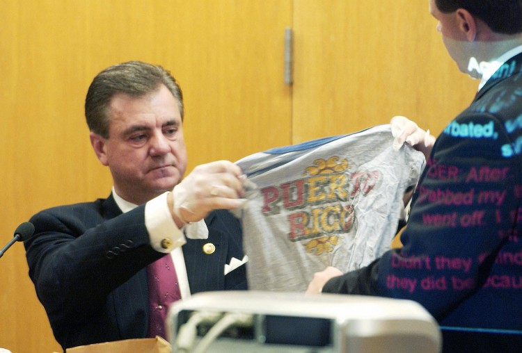 Larry Thomas, of the Kansas Bureau of Investigation, holds up a t-shirt that was taken from the head of Joey Otero, a young victim of the admitted BTK serial killer Dennis Rader, on the first day of  sentencing hearings at the Sedgwick County Courthouse on Aug. 17, 2005 in Wichita. 