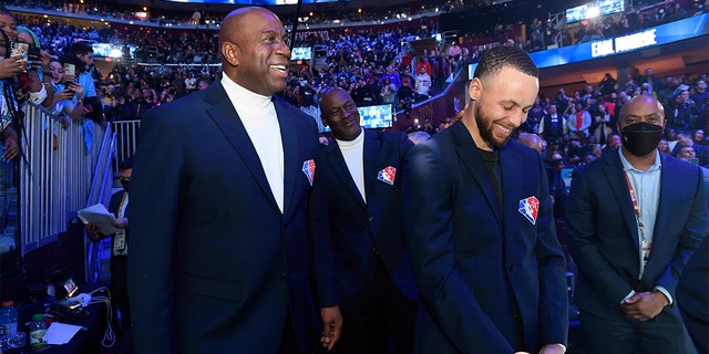 Magic Johnson and Steph Curry smile