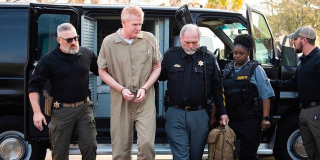 Alex Murdaugh in a prison jumpsuit being escorted by police