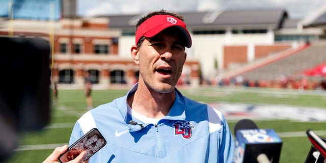 Liberty coach Jamey Chadwell speaks to the media