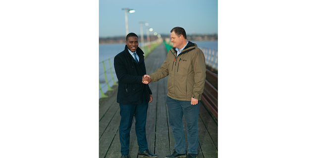 attorney Jeremiah Ingunnbole, left, shaking hand of Adam Smith-Connor 