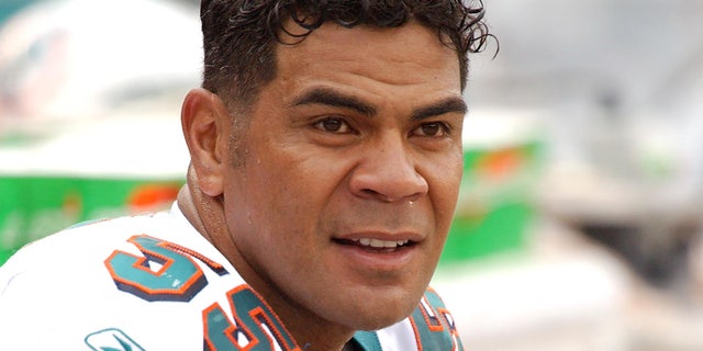 Junior Seau looks on field